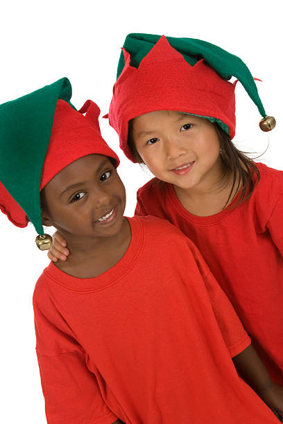 Young lady, gen Z girl, poses for Christmas celebration dressed as Santa She is smiling. She has her hands on face as surprising moment.