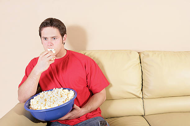 istock Watching Horror Movie Eating Popcorn 176056132