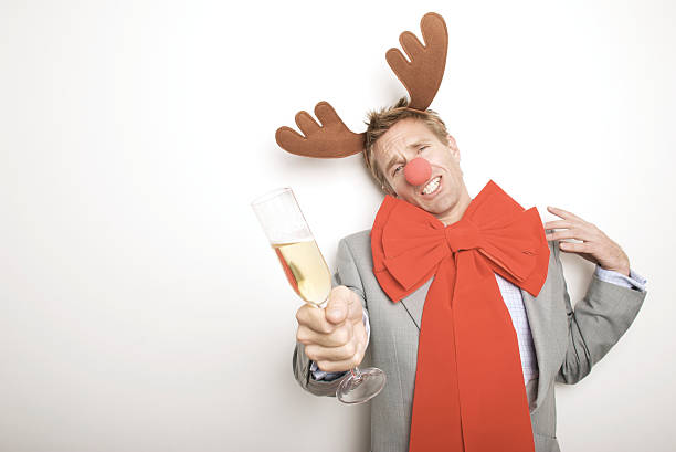 istock Red Nosed Reindeer Guy Holds Up a Toast 176057002