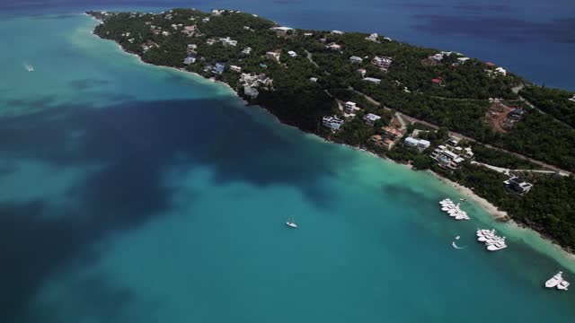 Amazing aerial view boats in water homes on mountain magen's bay st. thomas coki beach sapphire beach turquoise water waves blue sky white clouds east end red hook hills and mountains sun gleaming