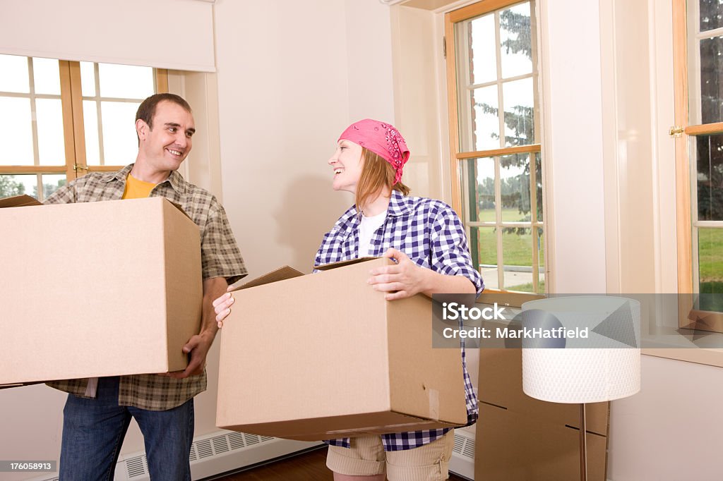 Couple Carries Boxes Into Their New House 30-39 Years Stock Photo