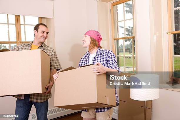 Couple Carries Boxes Into Their New House Stock Photo - Download Image Now - 30-39 Years, Adult, Adults Only