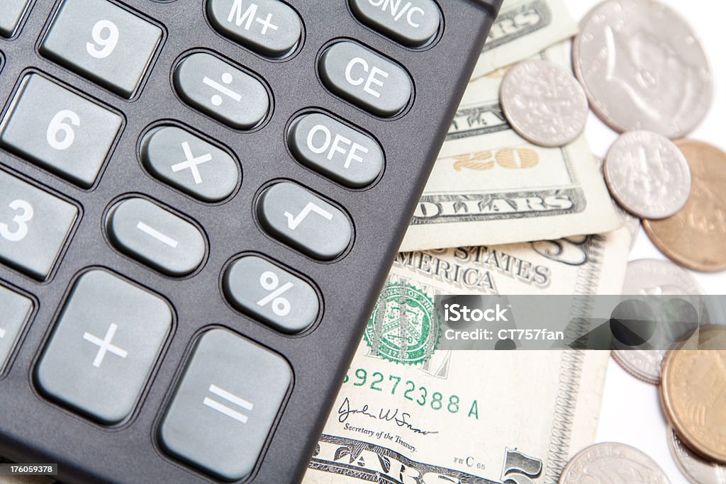 Calculator with US Currency Various US currency and a black calculator. Above Stock Photo