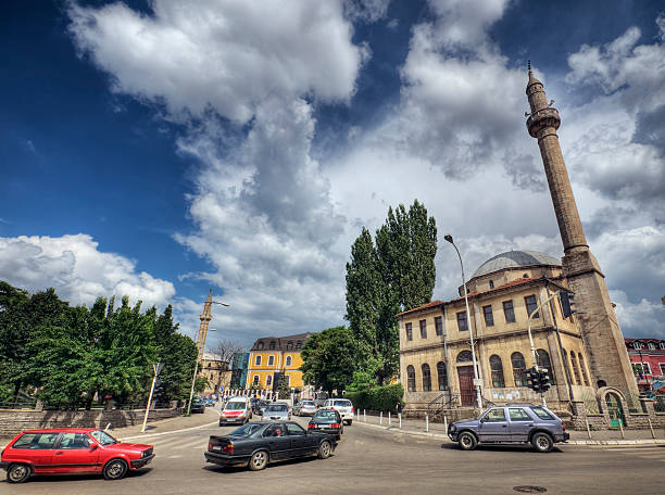 Street Scene - Prishtina Kosovo Prishtina Kosovo: Wide angle photo of a street scene showing the Grand Mosque to the right, with the Museum of Kosovo and the Carshi Mosque in the background. High dynamic range photo. pristina stock pictures, royalty-free photos & images