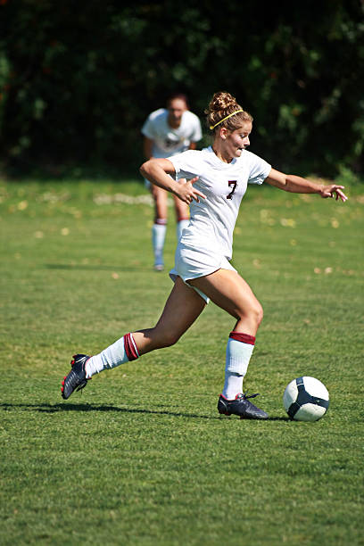 istock Attractive Female Soccer Player Dribbles with Pronounced Forward Intensity 176060246