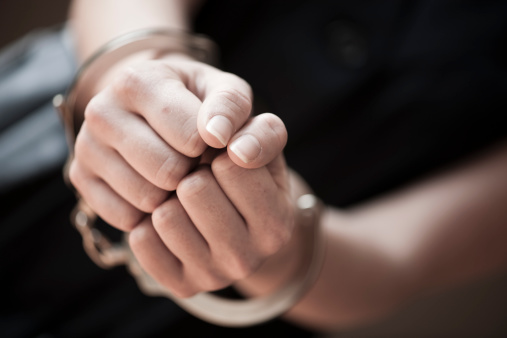 Woman in handcuffs, close-up of hands. HQLypse 2009