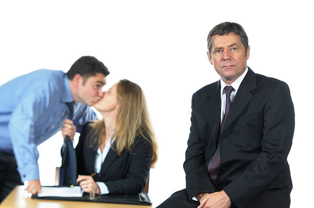 Business Man and his Team Misbehaving Behind Him