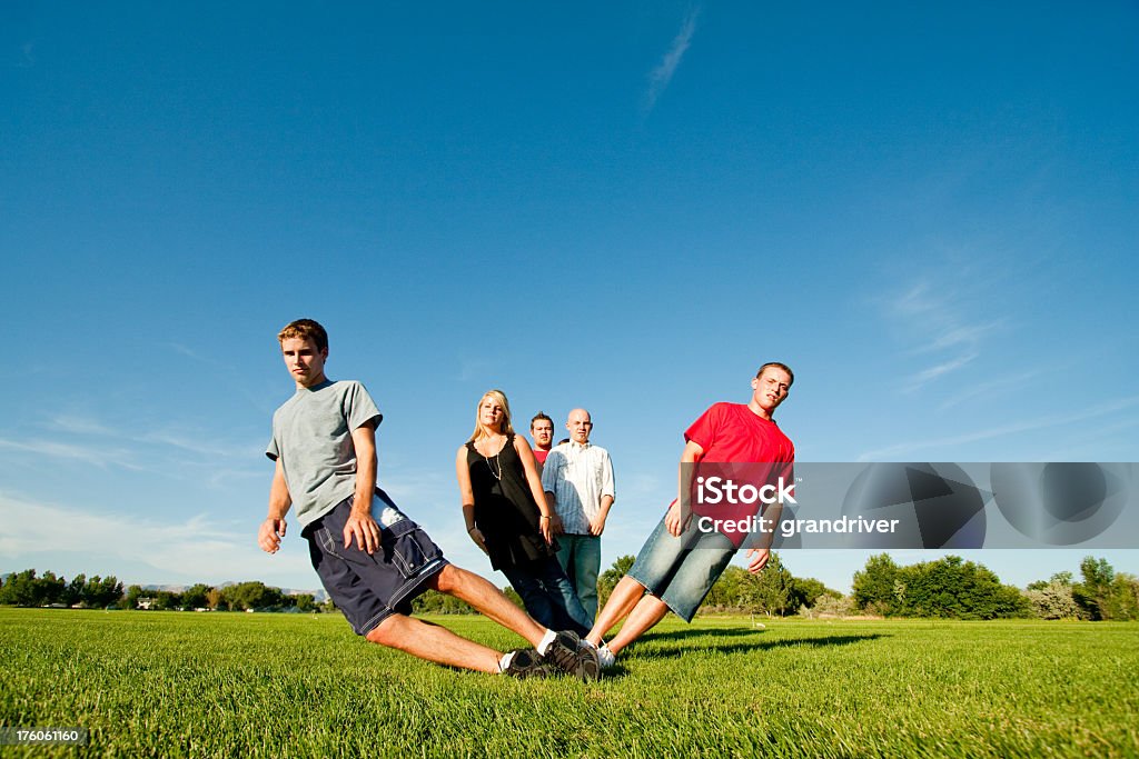 Teens Posing and Falling in a Field Five Teens in a field standing in line falling Beautiful People Stock Photo