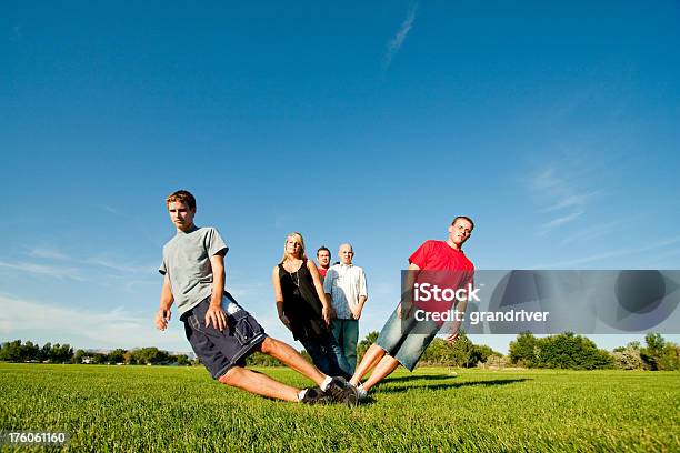Teens Posing And Falling In A Field Stock Photo - Download Image Now - Beautiful People, Bizarre, Concepts