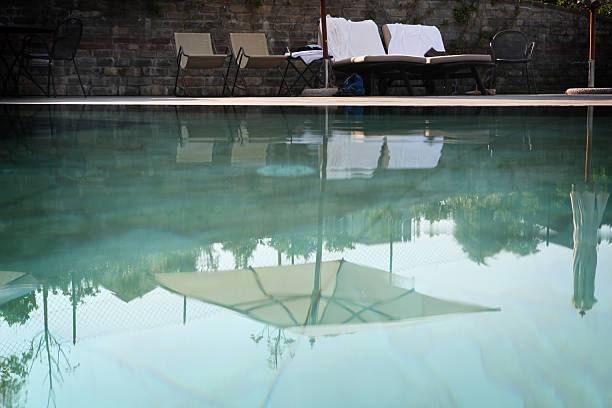 istock Reflection of tanning bed and umbrella in pool 176061199