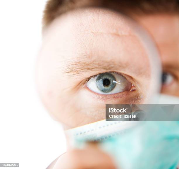 Human Eye Magnified Male Doctor Stock Photo - Download Image Now - Doctor, Magnifying Glass, 30-34 Years