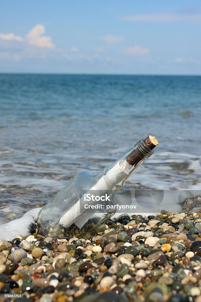Message in a Bottle "Message in a bottle with cork on the beach, letter inside" Assistance Stock Photo