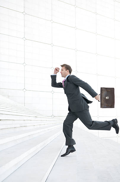 istock Businessman Bounds Up White Staircase 176061859
