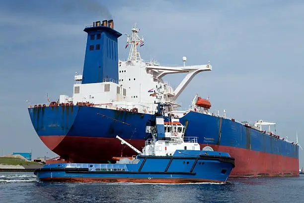 "Oiltanker with tug-boat in the harbour of Rotterdam, Netherlands"