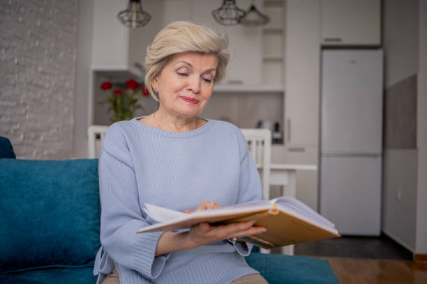 istock Senior woman reading book at home 1760624945