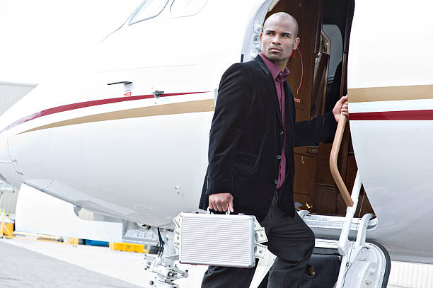 istock Affluent Travel - Man boarding jet with briefcase and cash 176062837