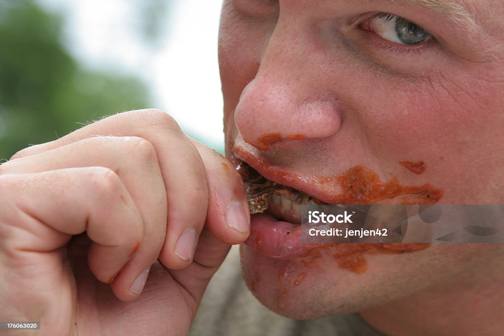 Messy Eating Adult male eating BBQ Turkey at an outdoor festival. Chicago - Illinois Stock Photo