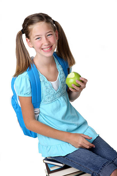 istock Schoolgirl Eating Apple 176063087