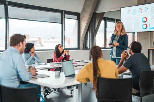 istock Mature Female Manager Showing Statistics to Multi-ethnic Team 1760631031