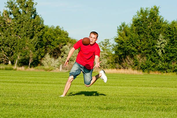istock Young Man Catching Football 176063262