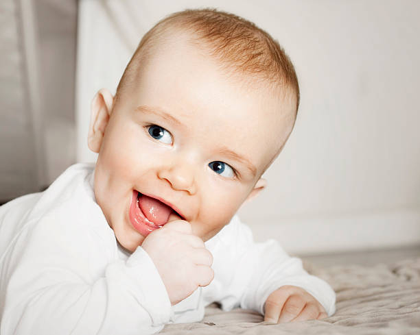 istock Baby smiling and sucking his thumb 176063286