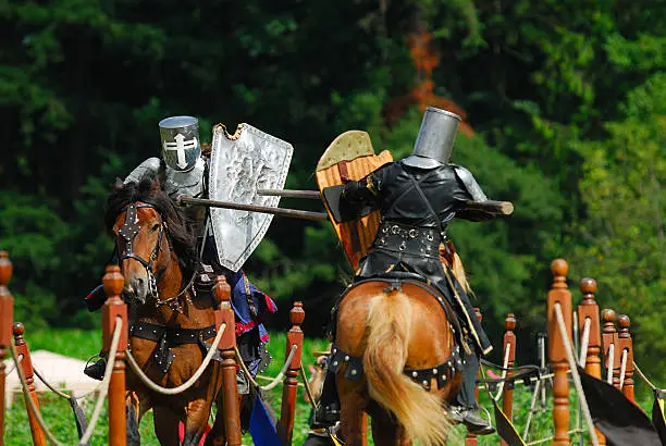 Two medieval knights jousting.