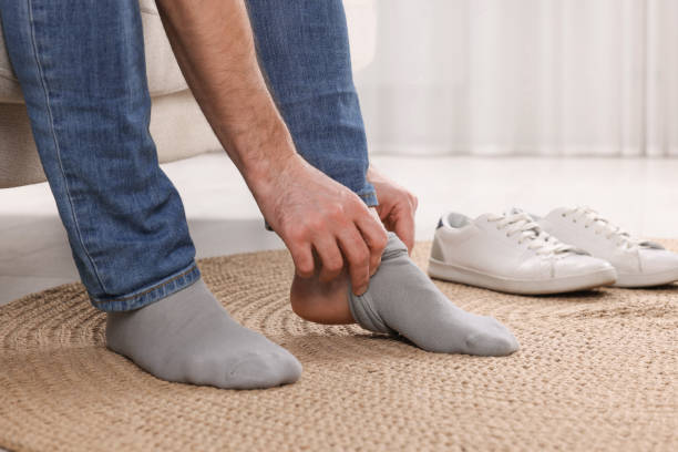 istock Man putting on grey socks at home, closeup 1760644291