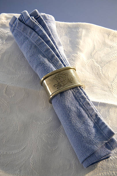 Dining napkin with gold napkin ring on red background