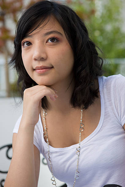 istock Young Woman Thinking With Chin On Hand 176065469