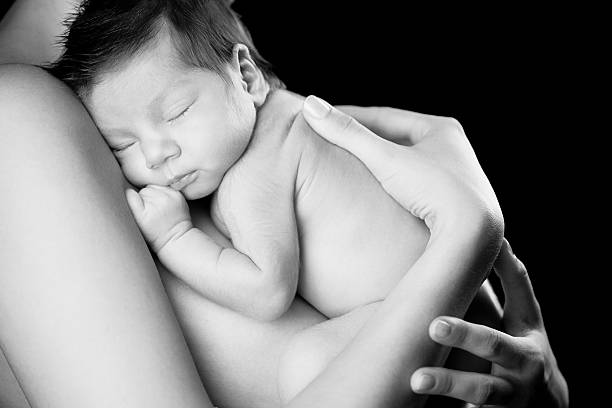 istock mother holding newborn 176065488