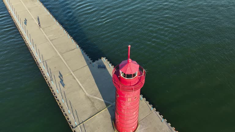 View of the lighthouse and channel pier in Autumn.