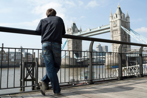 Man looking at the Tower Bridge in London