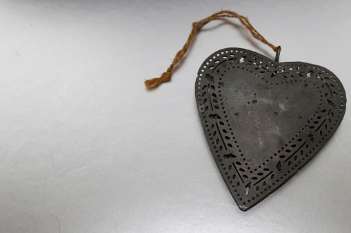 Rustic metal heart with cord for hanging. For Christmas decoration or window decoration or other occasions.