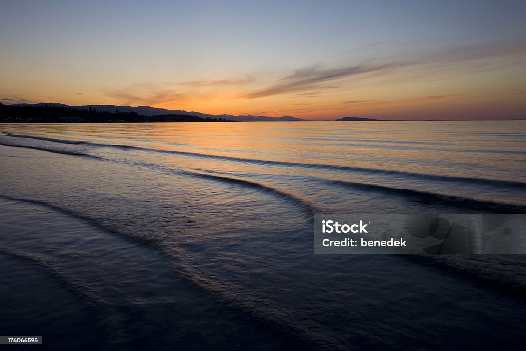 Gentle waves serene ocean beach Gentle waves at a serene ocean shore. Beach Stock Photo