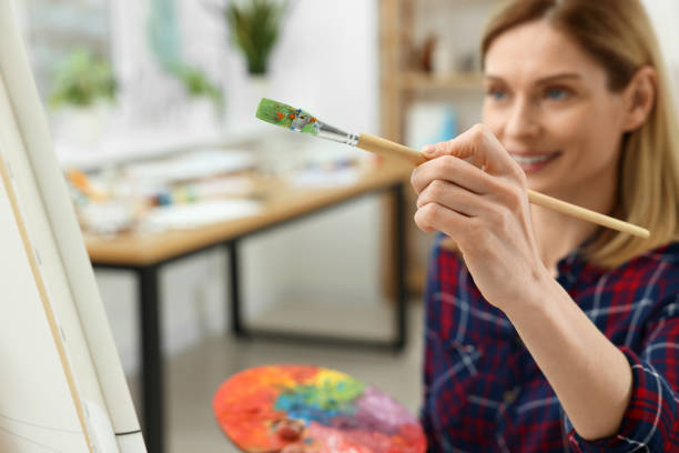 istock Woman painting on canvas in studio, selective focus. Creative hobby 1760667846