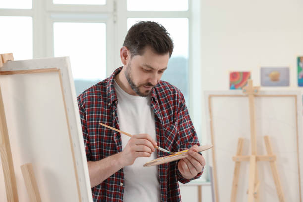 istock Handsome man painting in studio. Creative hobby 1760669075