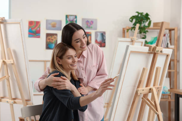 istock Artist teaching her student to paint in studio. Creative hobby 1760669531