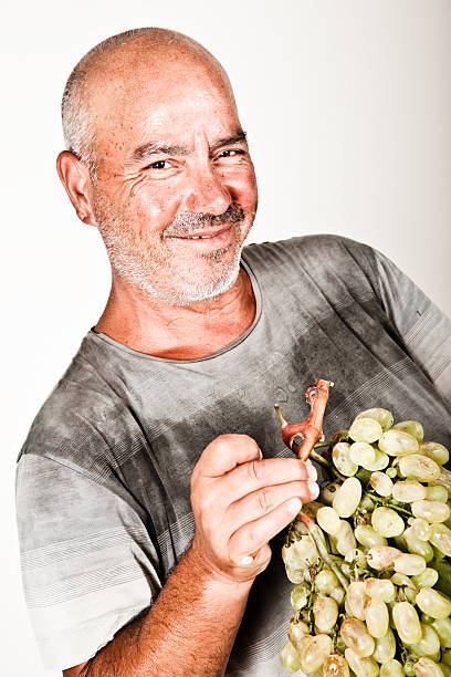 istock Man holding a bunch of grapes 176067071