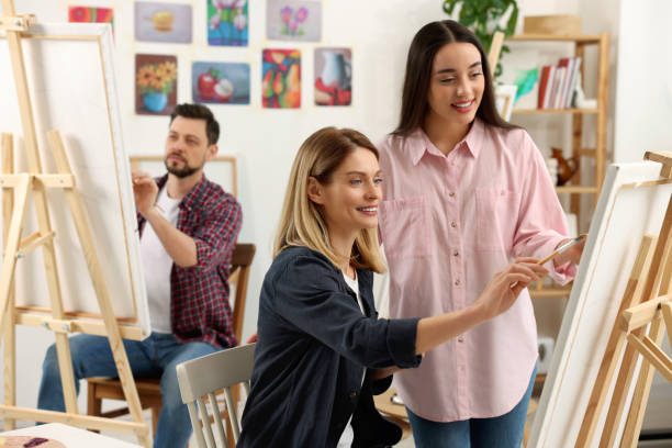 istock Artist and her students having painting class in studio. Creative hobby 1760673119