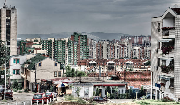 Grunge City Neighborhood in the Kosovar capital of Prishtina showing communist-era appartment buildings crowded together in the distance. High dynamic range photo. Contrast increased and saturation decreased in post processing. pristina stock pictures, royalty-free photos & images