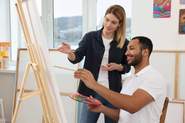 istock Artist teaching her student to paint in studio. Creative hobby 1760675904
