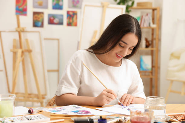 istock Beautiful young woman painting in studio. Creative hobby 1760675909