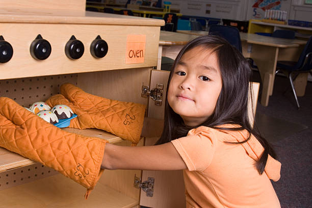 istock Girl using toy oven at her preschool 176067743