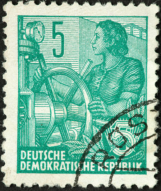 istock woman operating a large industrial valve. 176067760