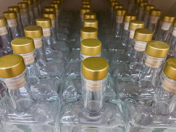 istock Empty Glass Bottles with Gold Lids on the Shelf 1760678281