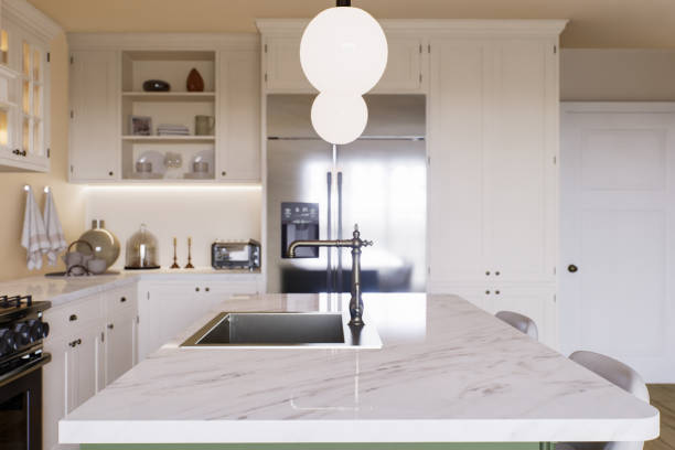 istock Kitchen with marble countertops and blurred kitchen background to display products on the surface. Kitchen interior with household appliances and utensils. 3D rendering 1760687078