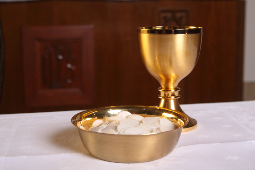 Communion wafers and chalice on the Altar of a Catholic Church