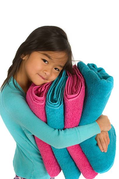 Sweet little girl holding blue and pink towels