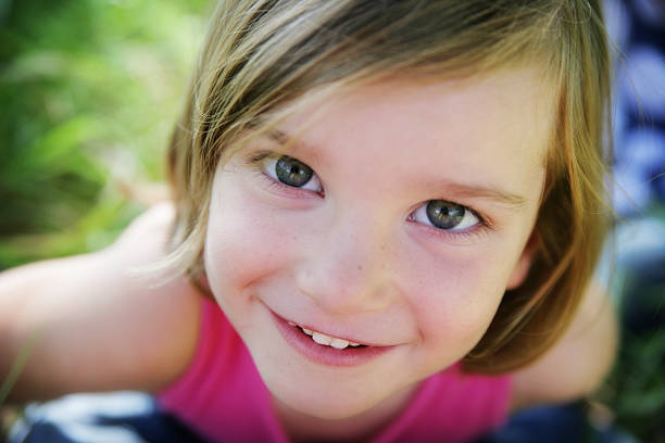 istock Adorable Smiling Little Girl Looking Up at Camera 176071059