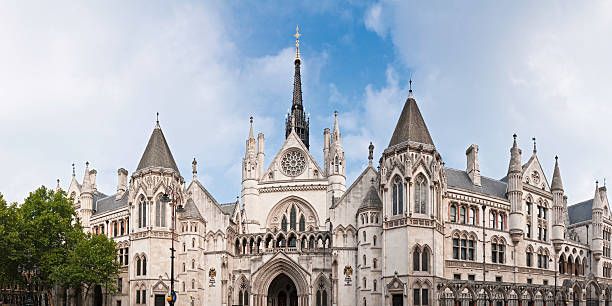 London Royal Courts of Justice Strand Holborn panorama "The ornate gothic facade of the Royal Courts of Justice, the Law Courts which form the High Court and Court of Appeal in England and Wales on The Strand, Westminster, London. ProPhoto RGB profile for maximum color fidelity and gamut." royal courts of justice stock pictures, royalty-free photos & images